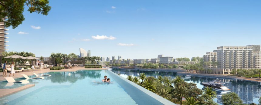 Infinity pool with comfortable lounge chairs overlooking the waterway